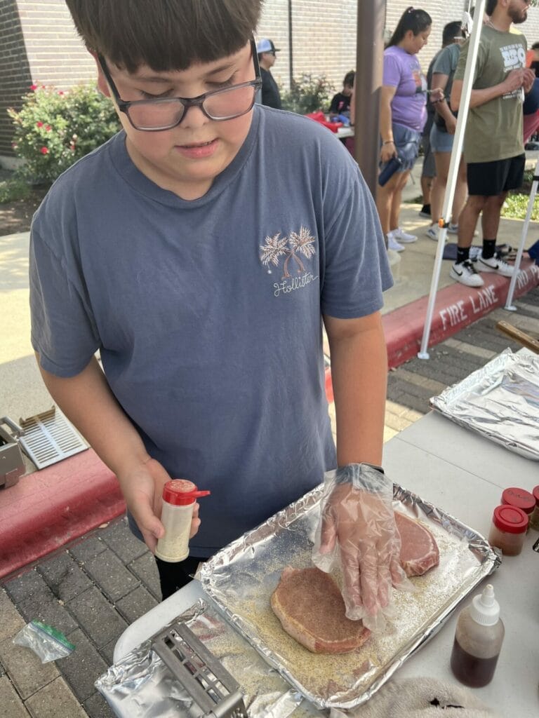 Austyn seasoning the pork chops